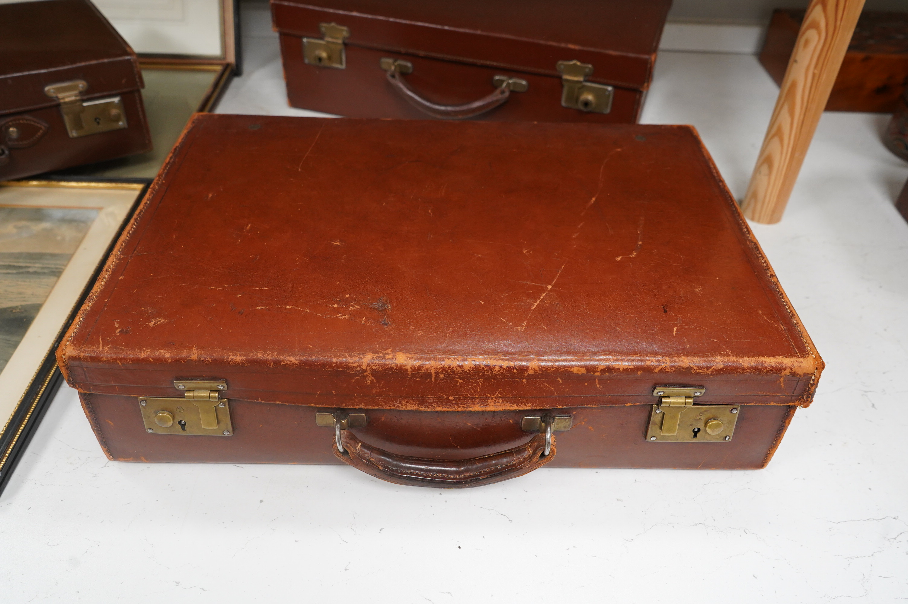 Three small vintage leather cases, largest 45cm wide